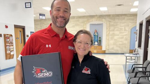 Lenell Hahn poses with a teacher