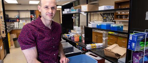 Dr. Kirschman standing in the research lab