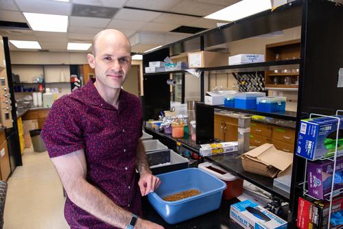 Dr. Kirschman standing in the research lab