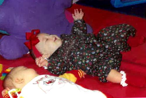 Alyssa playing on the floor as a baby in the USYC