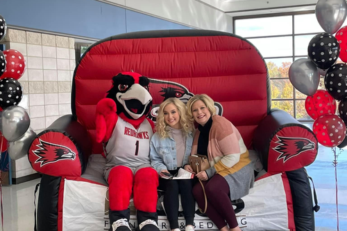 Alyssa and her mom sitting on a semo blow up couch
