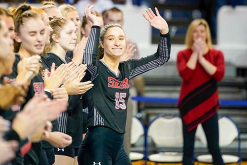 Claire Ochs waving to the crowd at a game