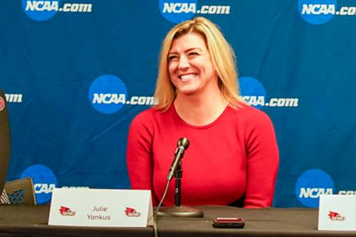 Julie Yankus sitting at a media table smiling