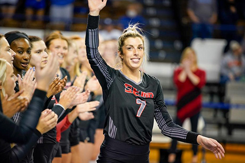 Laney Malloy waving to the crowd at a game