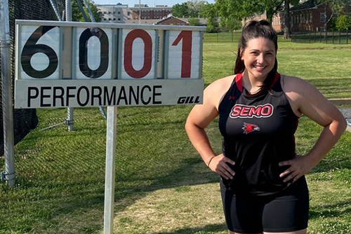 Nicole Humphreys stands next to her 6001 score
