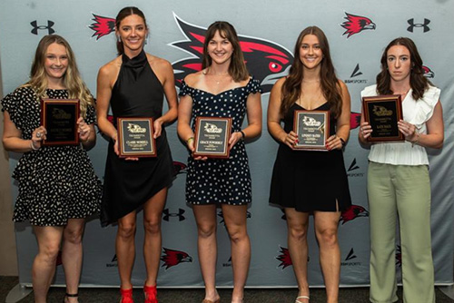 The 6 girls holding up their award smiling at the camera