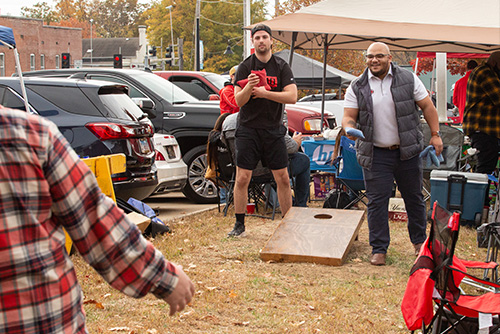 Fans at their tailgate playing the bag toss game