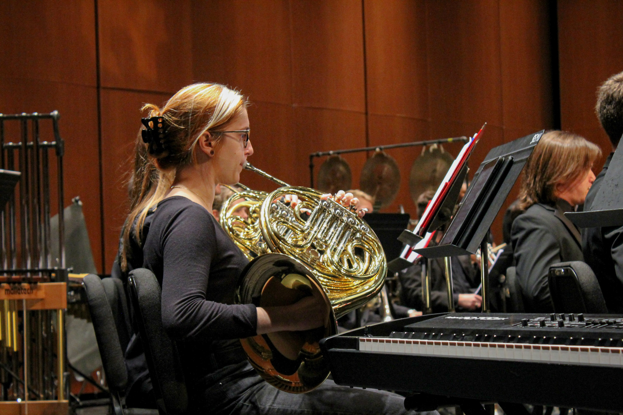 A Southeast musician warms up on the french horn.