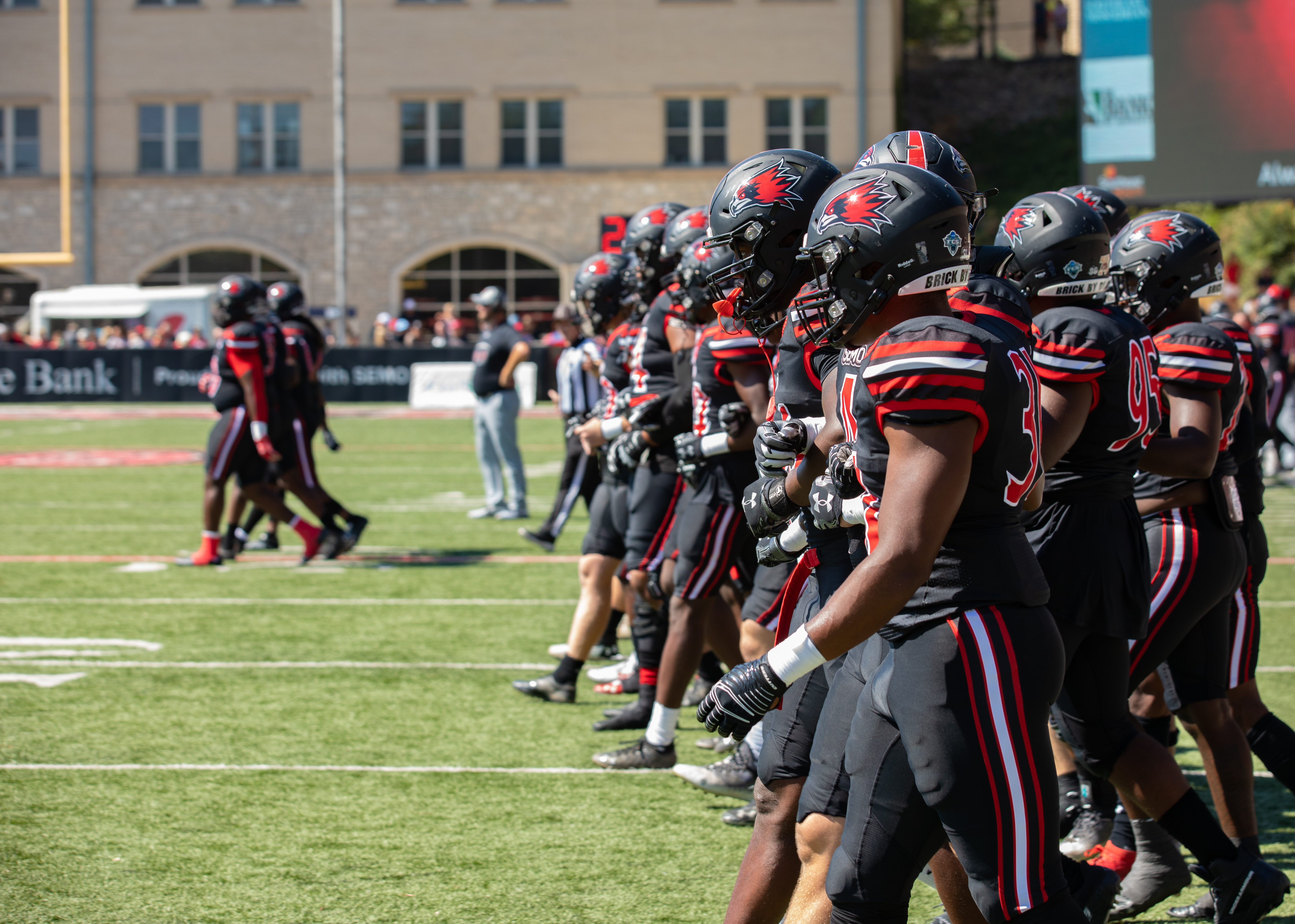 Redhawks walk onto the field before a football game