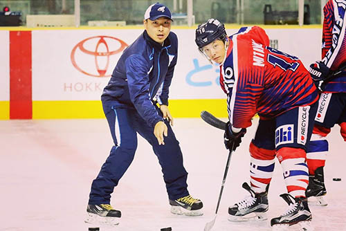 yuhei is out on the ice with his players coaching