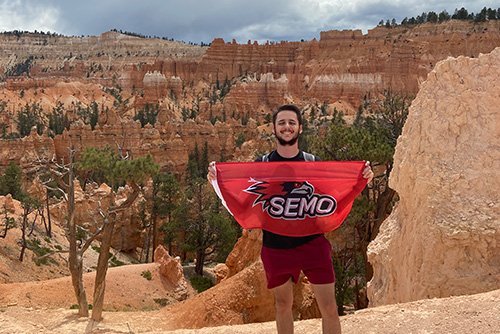 Zach Healy holding the SEMO flag