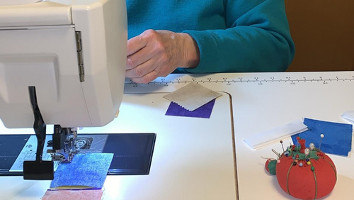 The photo shows Jan's hands and her sewing machine while she is hard at work.