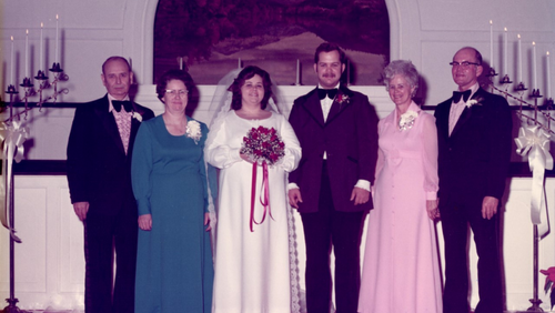 Ron and Jan smile for a photo with both of their parents after their wedding.