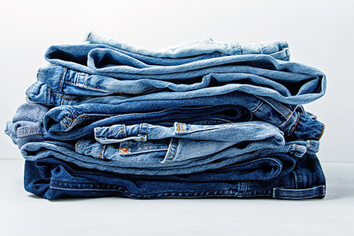 A stack of blue jeans is pictured