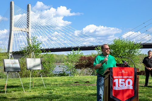 Donor standing at the podium talking about his story with the cape girardeau bridge in the background