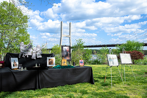 Table full of artwork with the cape girardeau bridge in the background