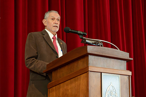 A man stands at a podium and speaks