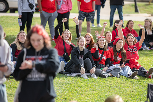 A group of girls cheer on a lawn