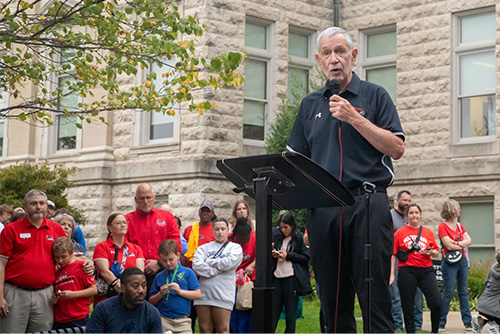 President Carlos Vargas speaks on a stage into a microphone
