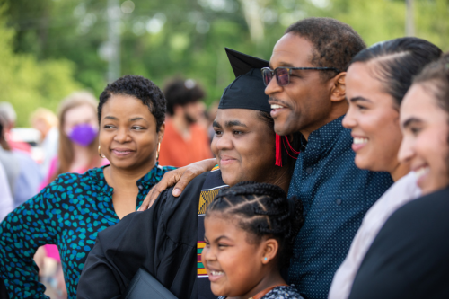 A family smiles for a photo after a senior graduates from Southeast.