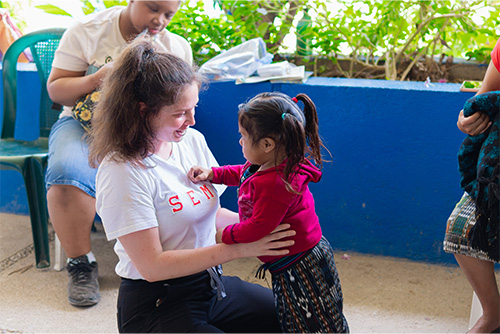 A SEMO student holds a small child