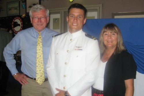 Bryce Aubuchon and parents smile for a photo at his official Naval Aviator ceremony.