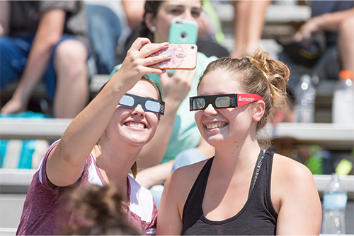 Two students take a photo wearing their eclipse glasses during the activities of the 2017 total solar eclipse. Southeast Missouri State University will once again be one of the best places to view the 2024 total solar eclipse.
