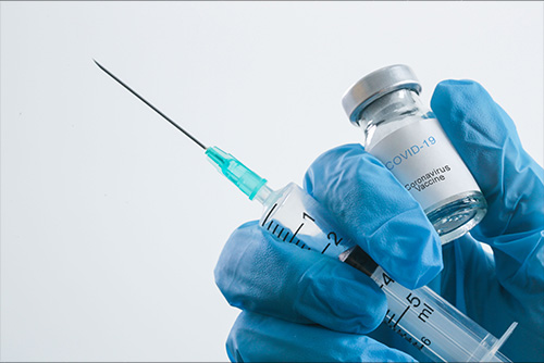 Needle and Covid-19 Vaccine bottle