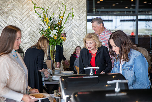 Group of Alumni in the line for the food