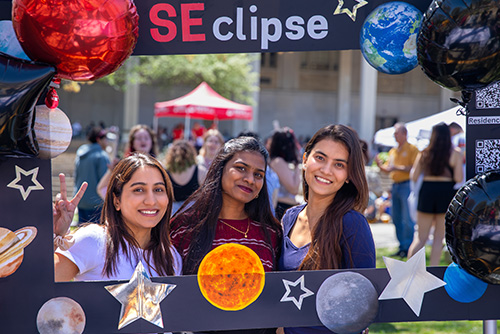 Students in a frame smiling at the camera for the SEclipse