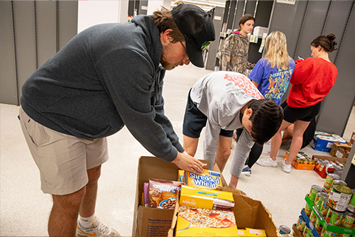 Greek student packing up boxes for the food bank.