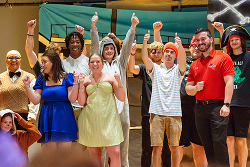 Group of Greeks standing on stage at Greek Sing in their costums for the show Peter Pan.