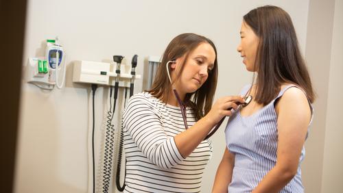 Nurse Practitioner Rachael Jenkins assists a student in the Campus Health Clinic.