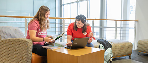 Two southeast students working together to help each other figure out their homework