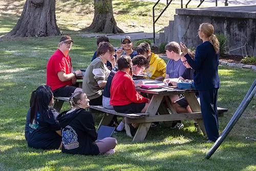 Students sitting outside and enjoying the outdoors together
