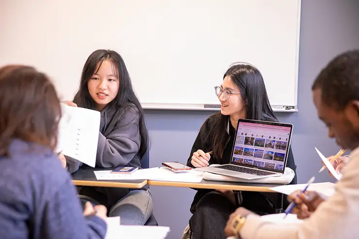 Southeast Missouri State University students collaborating in a classroom group discussion over a worksheet.