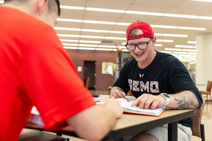 two SEMO students work together in the library to study with academic resources from supportnet