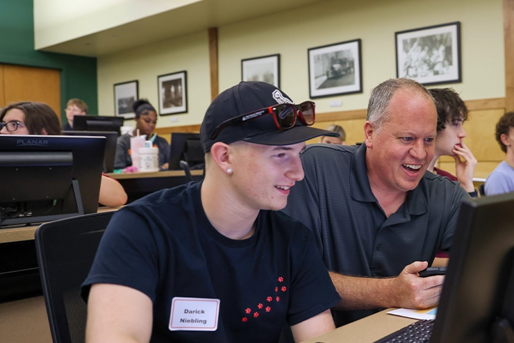 an Professor works with a student during first step orientation