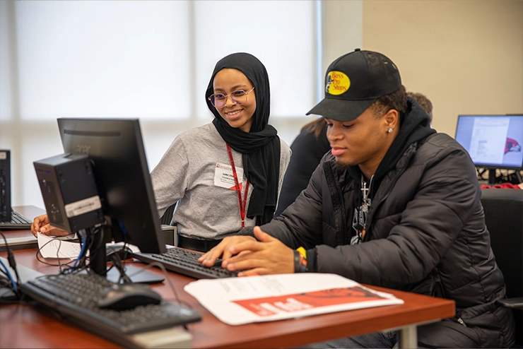 Two Students in the computer lab helping one another for supportnet