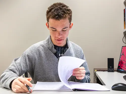 a SEMO student sits at a study table in Kent library working on an assignment