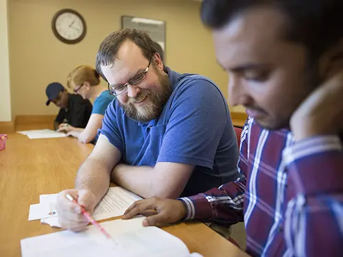 a semo student sits with a tutor and works through an assignment