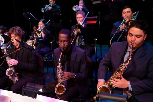 Music students play instruments with the jazz band.