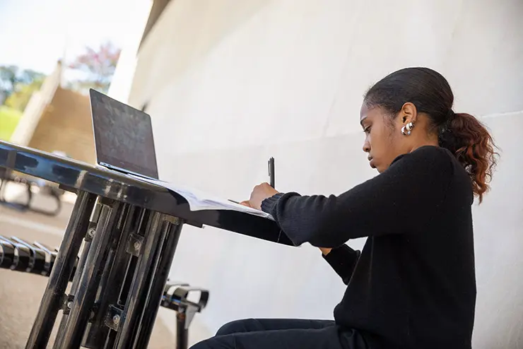 a semo student sits at a table working on homework
