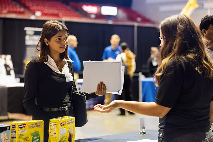 A student talks with an employer