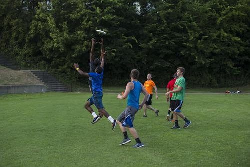 Students jump to intercept during a game of ultimate frisbee at Recreation Service’s Brant Field. 