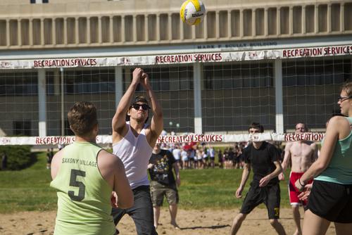 Students play sand volleyball at Recreation Service’s Parker Field.