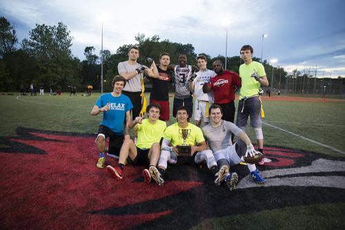 Flag football intramural champions pose with the trophy on Recreation Services’ turf field.
