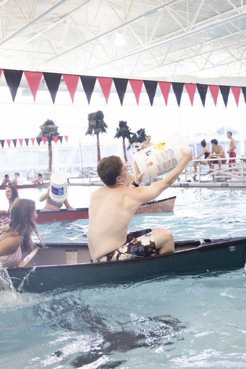 Students in canoes play battleship at the Aquatic Center during Camp Redhawk