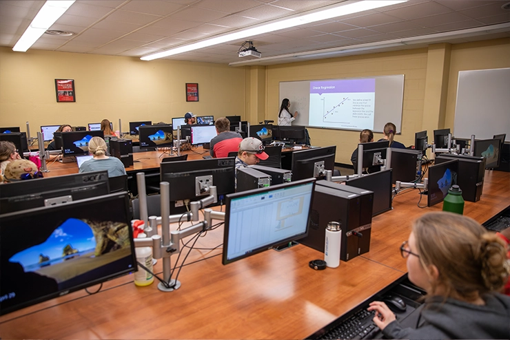 Students at a table using Canvas