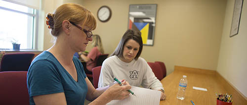 Student working with teacher on a paper